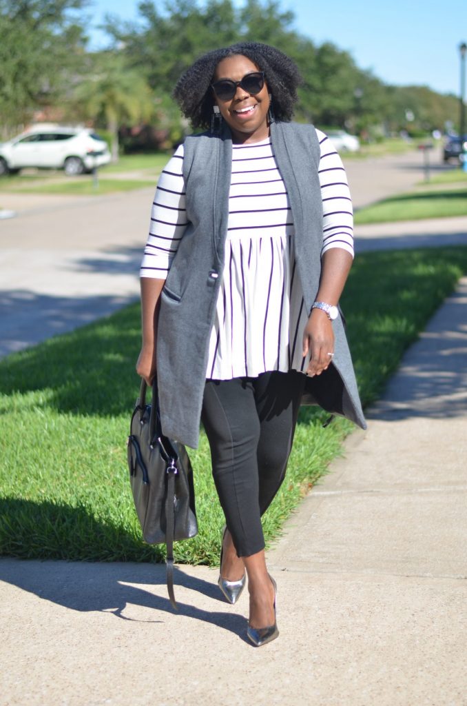 striped quartered length flowy top and grey wool vest with black leggings